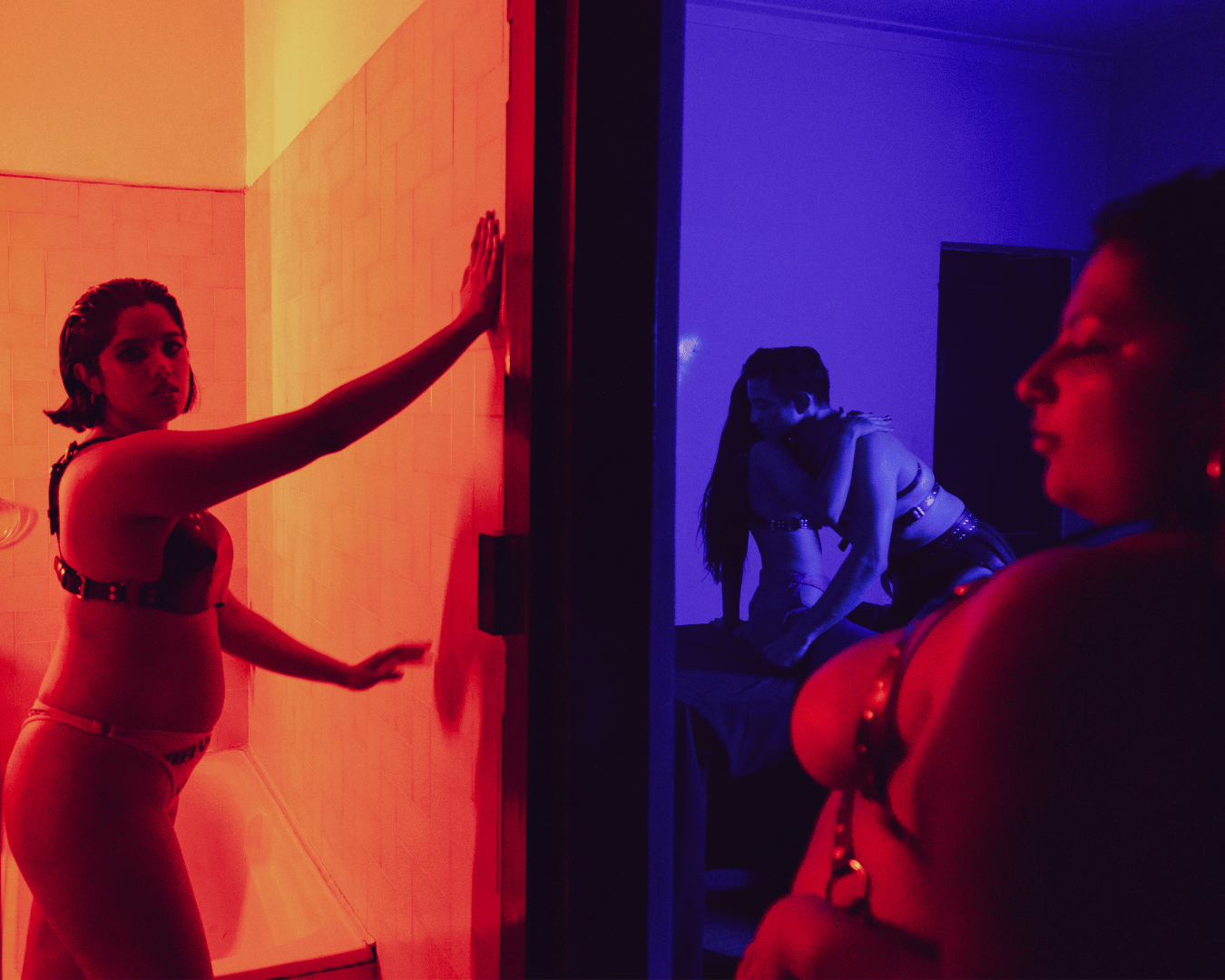 models in orange and blue lit hallway scene