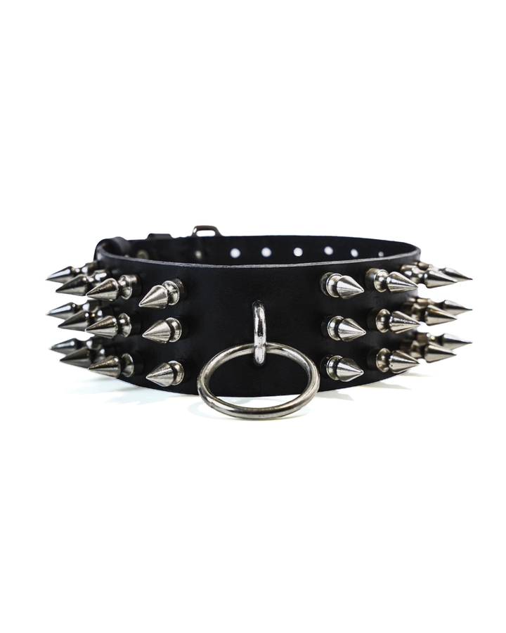 Subculture Rave Collar front view on white background — wide black genuine leather collar with three rows of silver cone spike studs and centre O-ring
