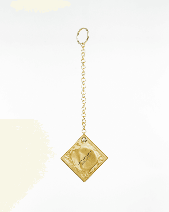 Condom Charm, genuine leather charm by Subculture, worn view