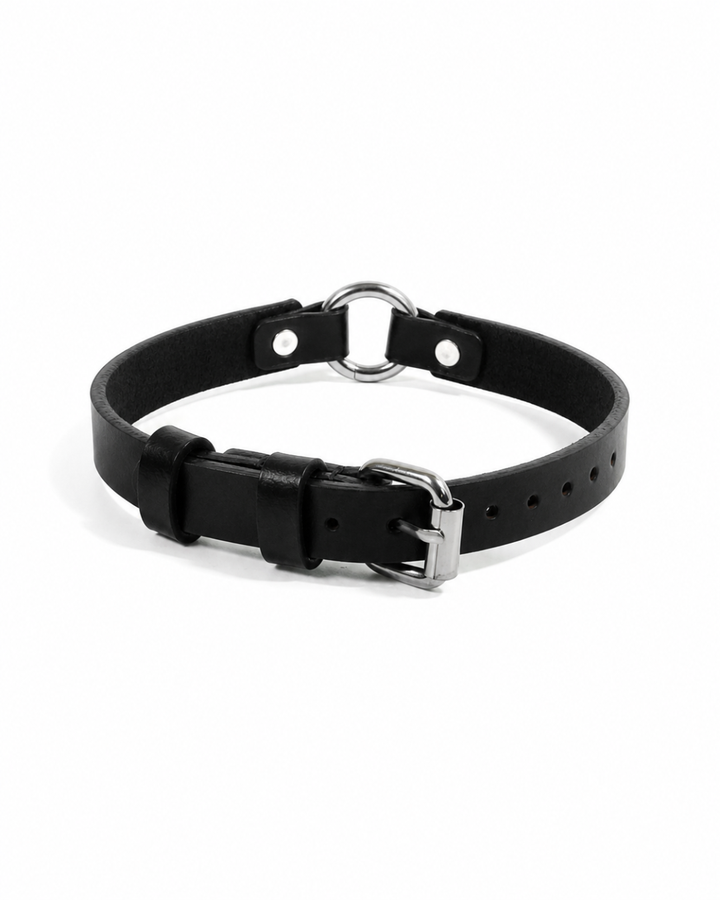 Black leather Halo Collar on white background showing silver O-ring at centre front, two flanking rivets, adjustable single pin buckle, and multiple adjustment holes
