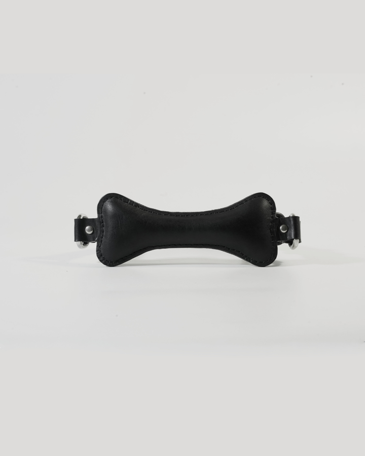 Back of Fetch leather bone gag showing SUBCULTURE embossed leather strap and roller buckle closure