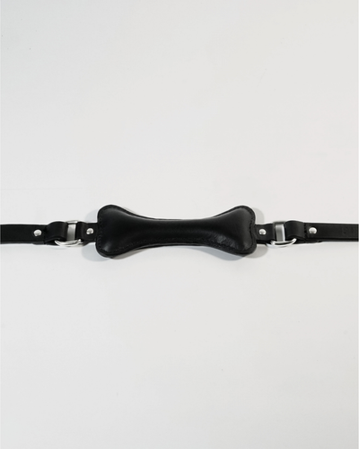 Fetch leather bone gag flat lay, black leather bone-shaped bite piece with D-rings on either side