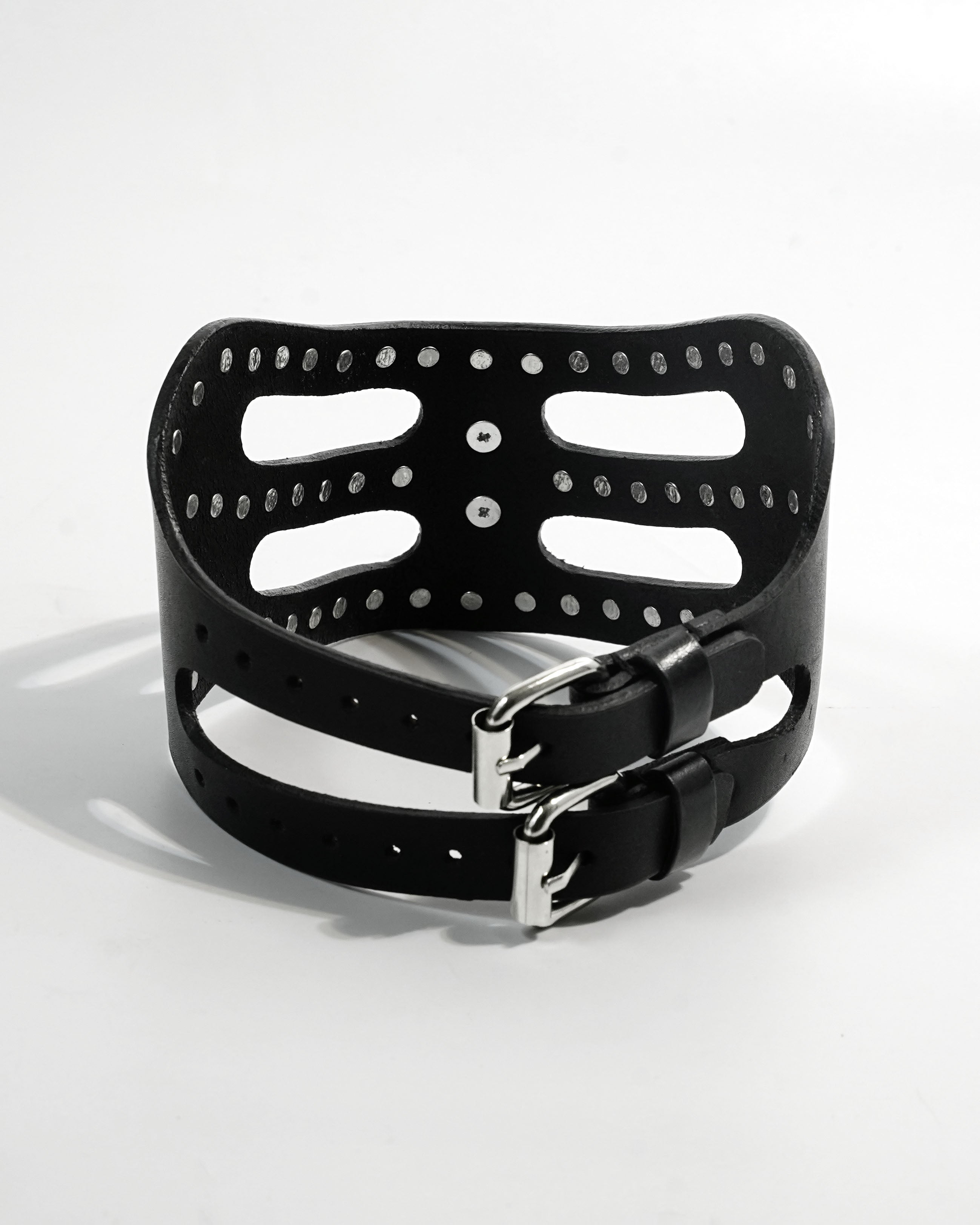 Cipher Collar front — architectural black leather collar with chrome stud detailing and cat-eye mask silhouette, chrome O-ring at center front, Subculture India