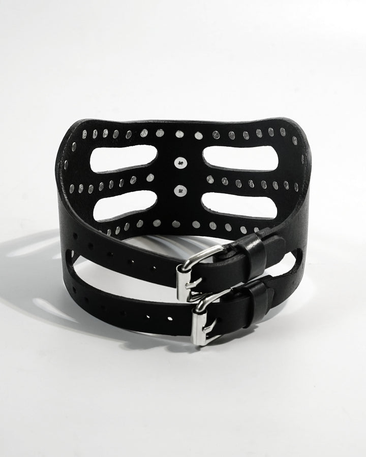 Cipher Collar front — architectural black leather collar with chrome stud detailing and cat-eye mask silhouette, chrome O-ring at center front, Subculture India