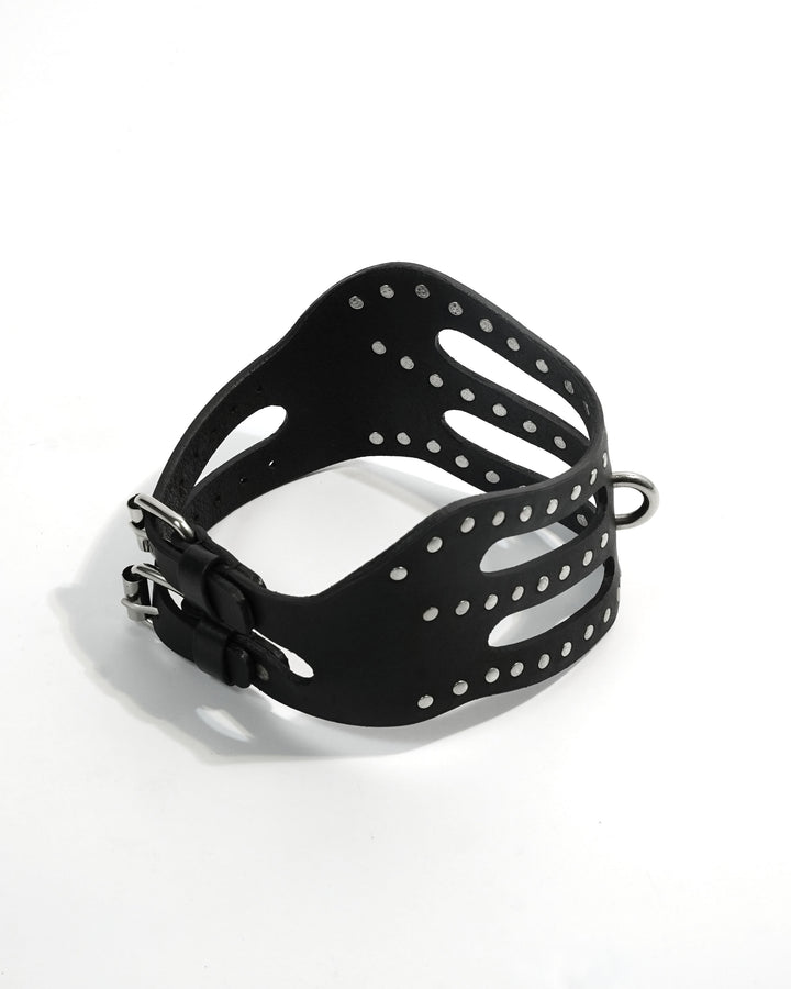 Cipher Collar angled view — wide-band black leather collar with hand-set chrome rivets and architectural cut-out panel design, Subculture India