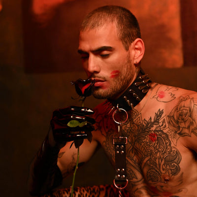Subculture Rave Collar on a tattooed male model in a red-lit gothic set, paired with a leather chest harness