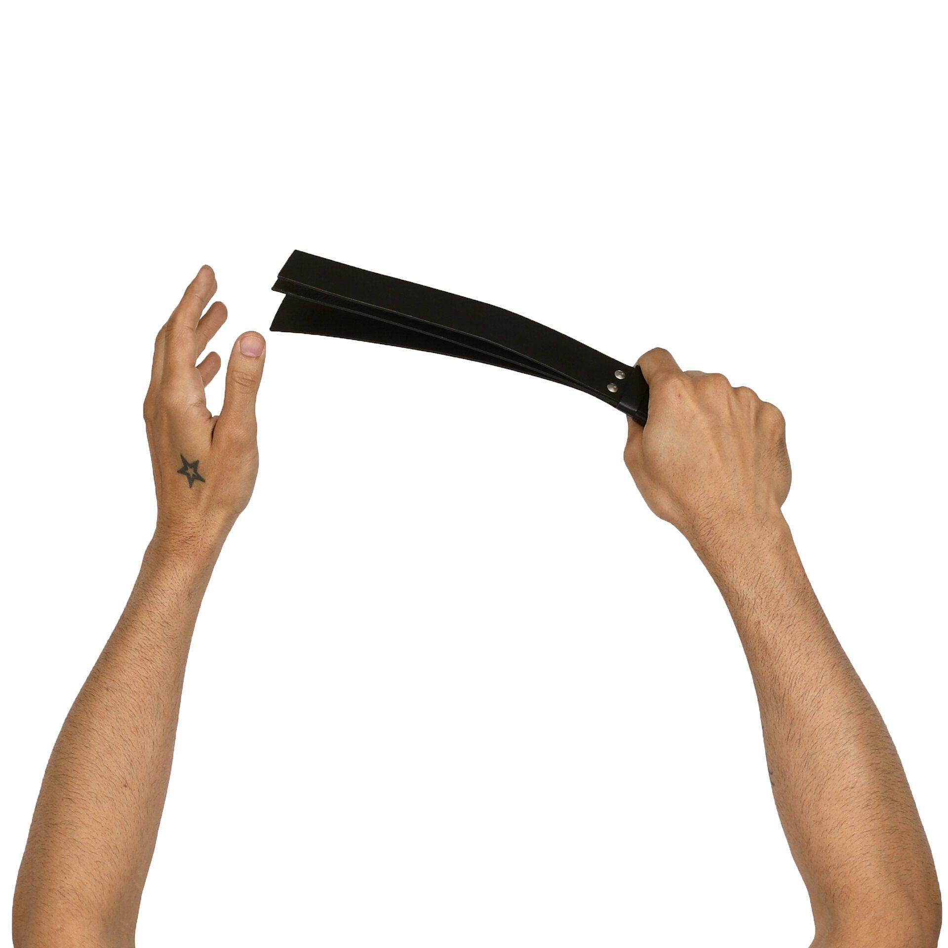Three layer Paddle Whip, genuine leather impact toy by Subculture, worn view